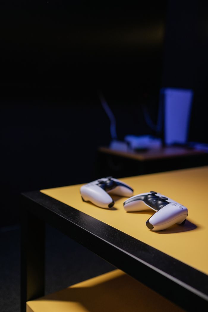 Minimalist indoor gaming setup showcasing controllers on a sleek table, perfect for home entertainment.